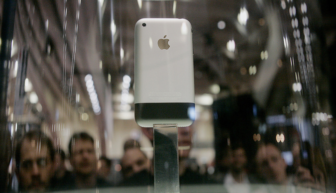 The new iPhone sits on display behind a glass case at the Macworld conference in San Francisco