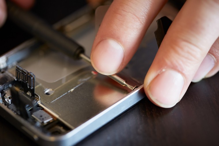 Hands fixing smartphone close-up