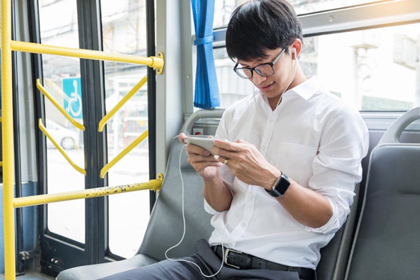 passenger transport people bus listening music play game while riding home 1423 3041